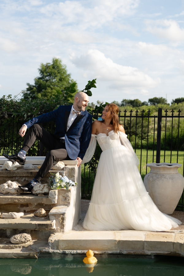 A groom and bride smiling at each other