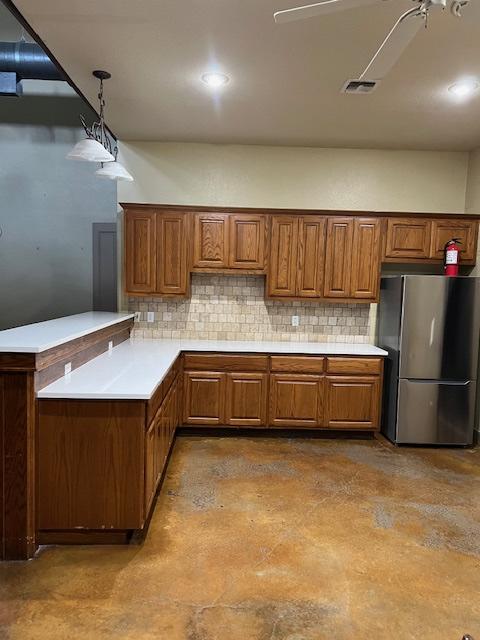 A corner kitchen with a refridgerator