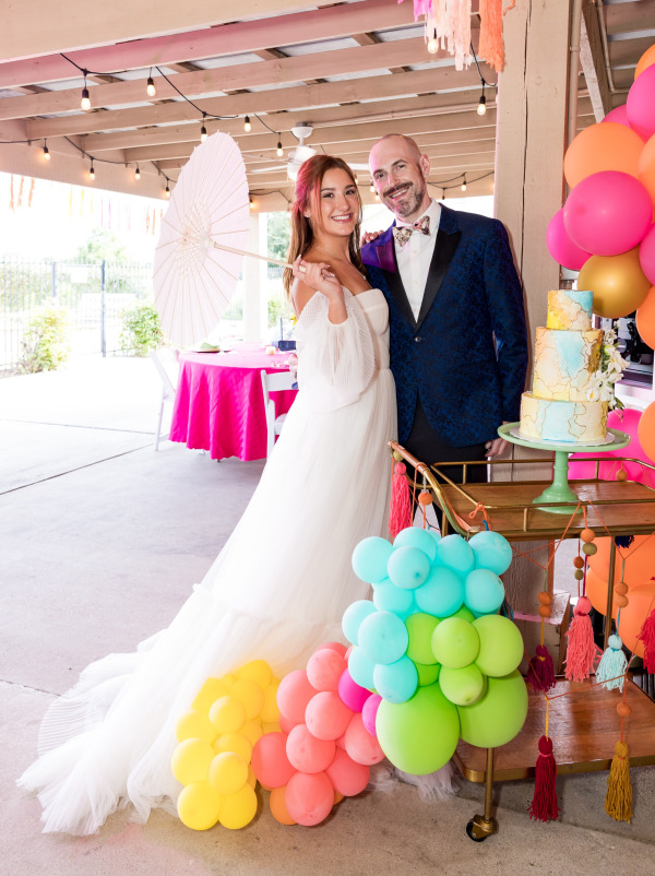 A bride and groom smiling at the camera