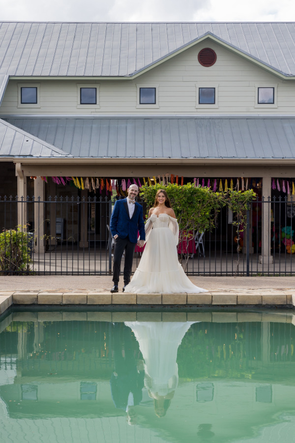 Couple posing together by the pool