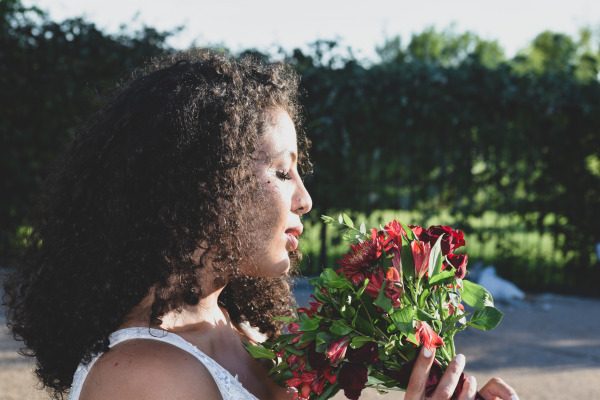 Bride smelling her bouquet of flowers