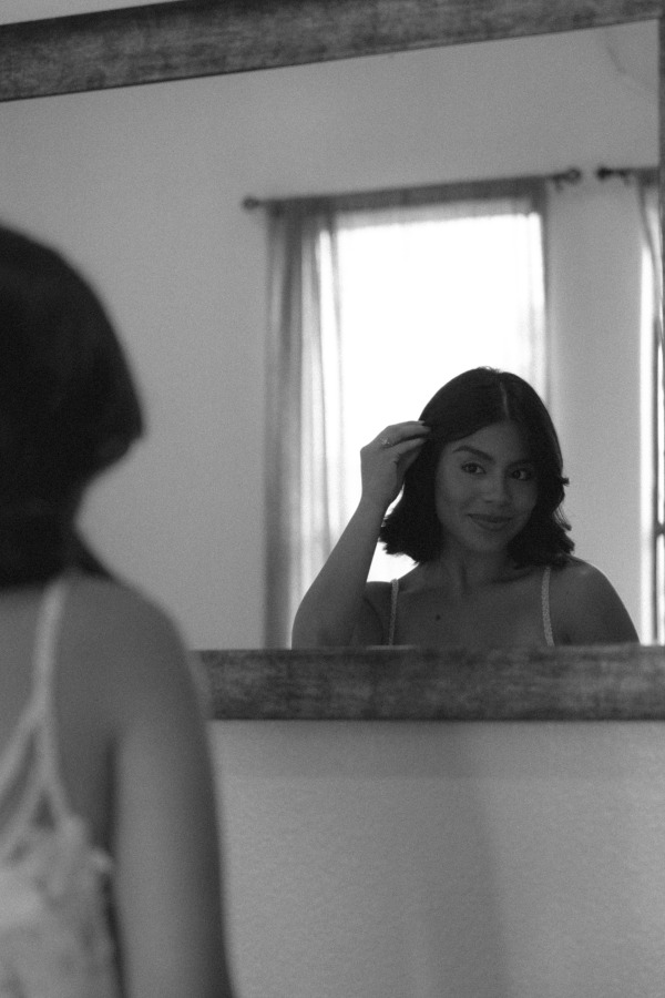 Bride looking at herself in a mirror