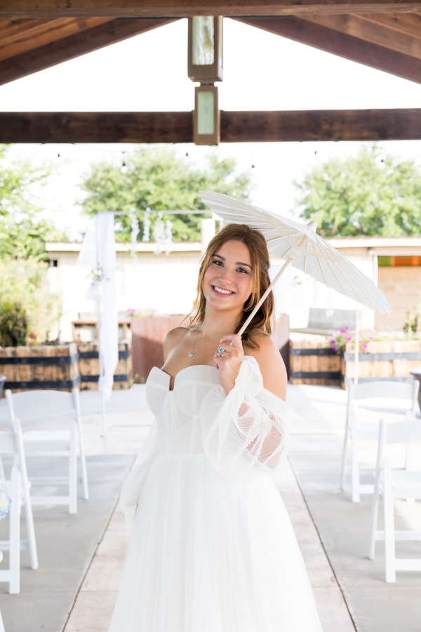 Smiling bride holding an umbrella