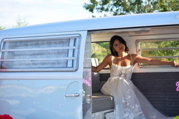 A bride smiles in a car