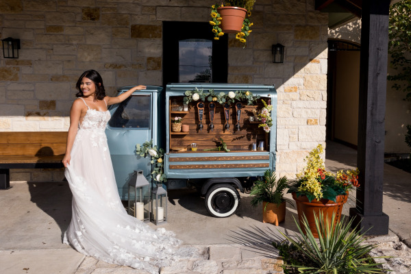 A bride posing by the beverage cart