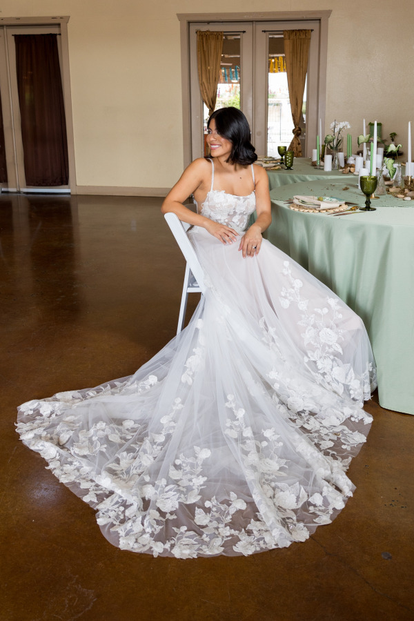 A smiling bride by a table